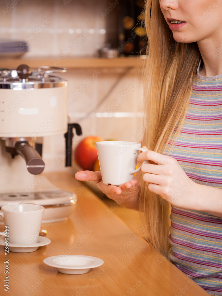 Happy woman holding cup of tea of coffee Happy woman holding cup of tea of coffee