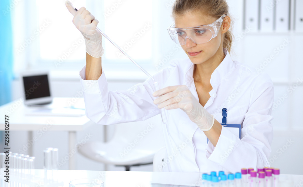 Female scientific researcher or blood test assistant at work in laboratory. Science, medicine and pharmacy concept Female scientific researcher or blood test assistant at work in laboratory. Science, medicine and pharmacy concept
