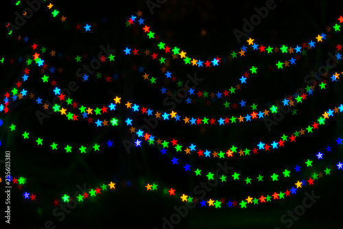 Abstract bokeh lights in the star shape with isolated black in background photo