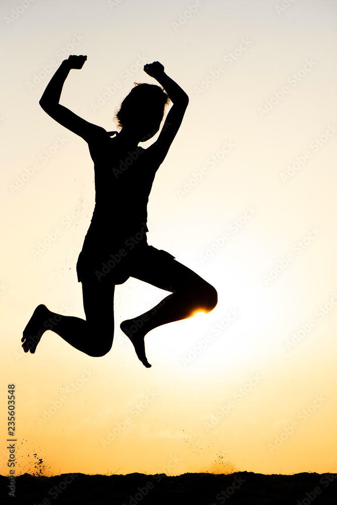Silhouette of Happy Woman and Fun Jumping on the Beach at the Day Time. Summer Time Vacation.