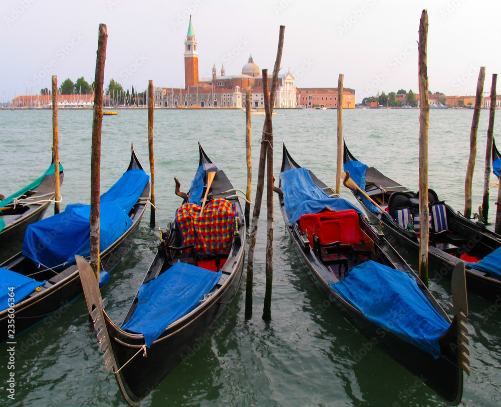 Colorful gondolas in Venice, Italy frame the island of San Giorgio Maggiore