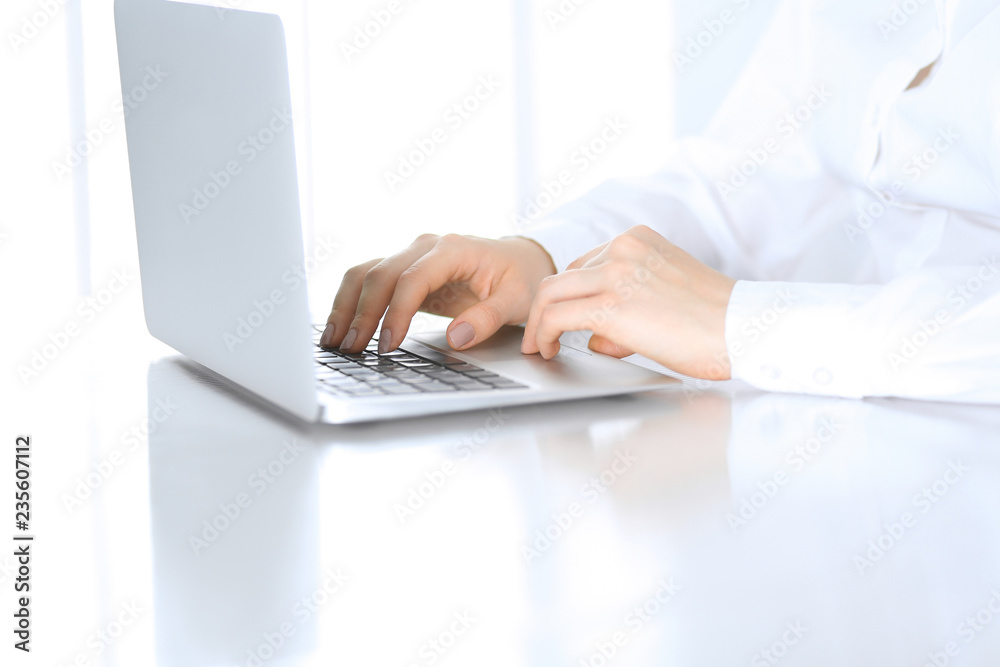 Close-up of business woman hands typing on laptop computer. Secretary at work in office Close-up of business woman hands typing on laptop computer. Secretary at work in office