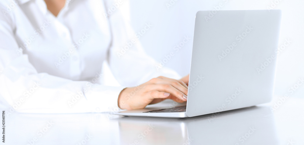 Close-up of business woman hands typing on laptop computer. Secretary at work in office Close-up of business woman hands typing on laptop computer. Secretary at work in office