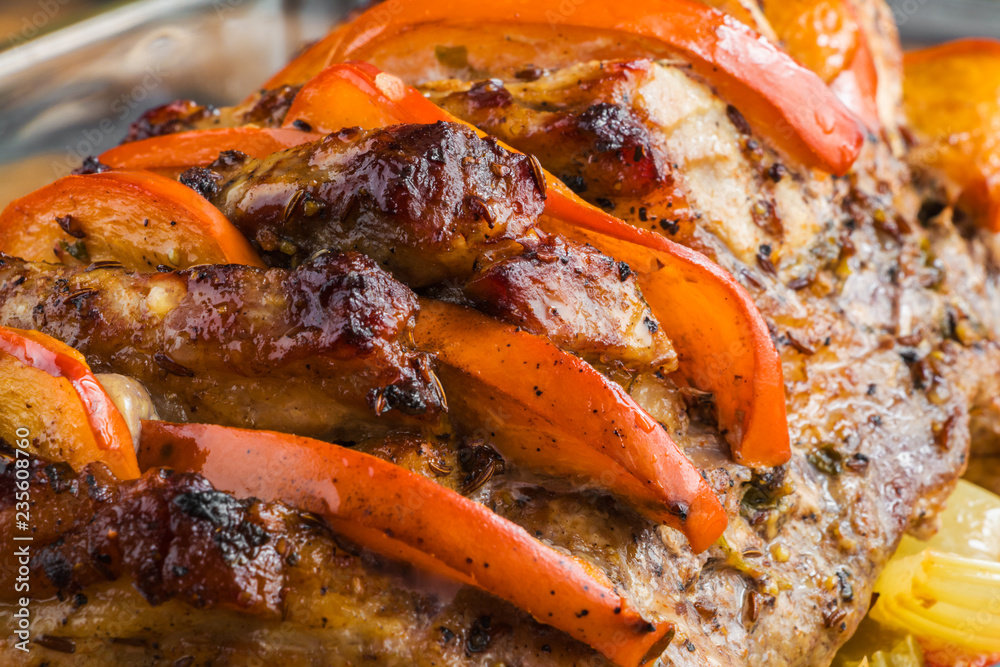 Spicy pork fillet baked with persimmon, apple, onion, carrot, bell pepper and celery, close-up Spicy pork fillet baked with persimmon, apple, onion, carrot, bell pepper and celery, close-up