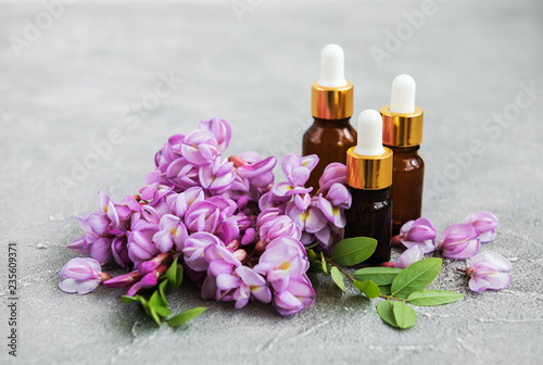 Essential oils and pink acacia flowers