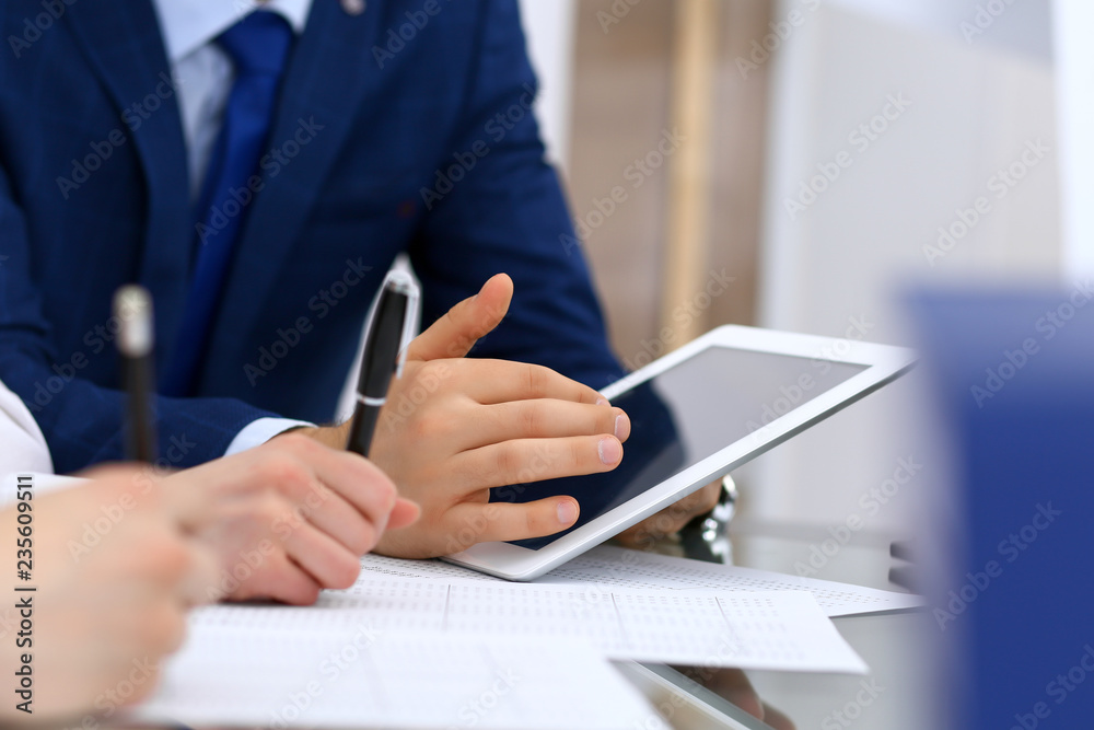 Bookkeepers team or financial inspectors making report, calculating and checking balance. Tax service financial document. Audit or meeting concept Bookkeepers team or financial inspectors making report, calculating and checking balance. Tax service financial document. Audit or meeting concept