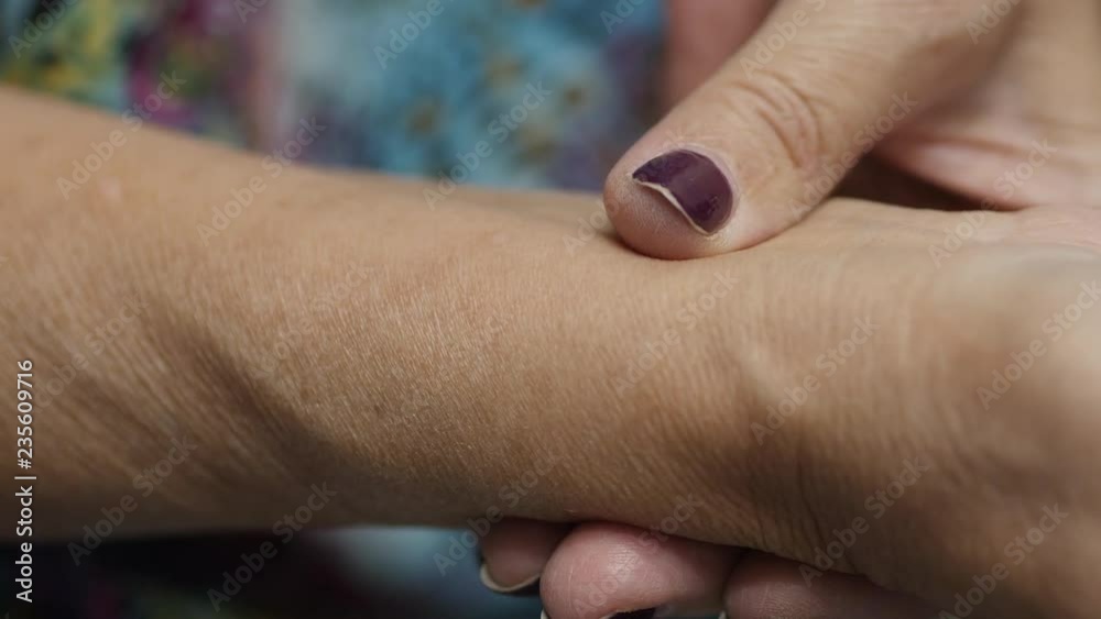An Elderly Woman Measures The Pulse With Her Finger An Elderly Woman Measures The Pulse With Her Finger