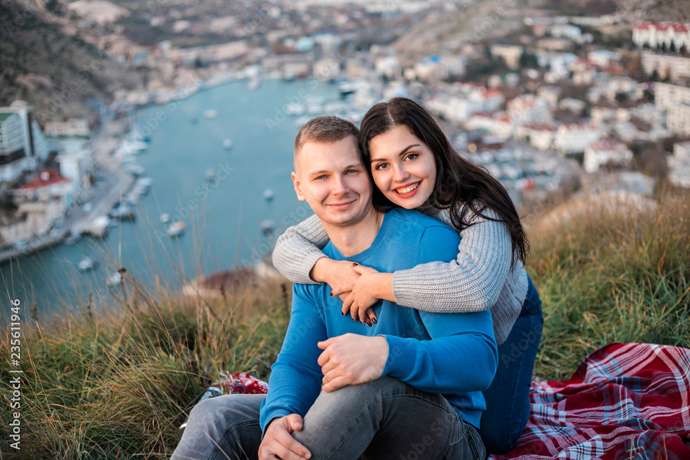Happy couple seating outdoor near Black sea. Happy couple seating outdoor near Black sea.