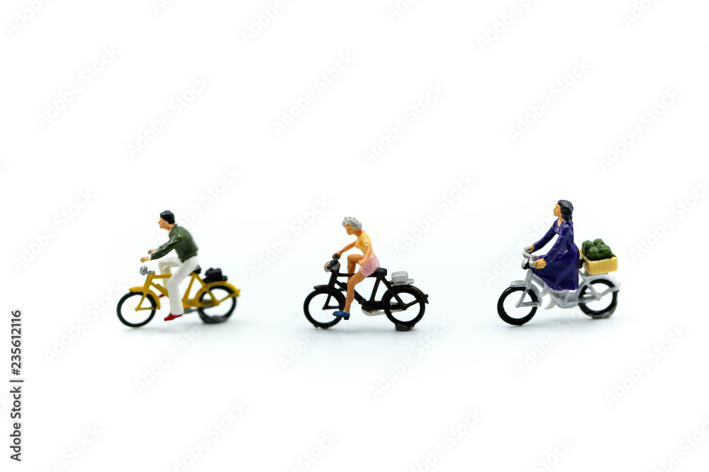 Miniature people : man and friend ride bicycle on white background.