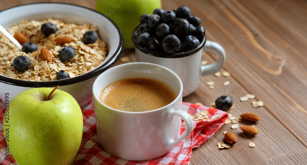 A healthy breakfast - Oatmeal porridge, boiled egg, milk, fresh berries and coffee. A great start to a new day. A healthy breakfast - Oatmeal porridge, boiled egg, milk, fresh berries and coffee. A great start to a new day.