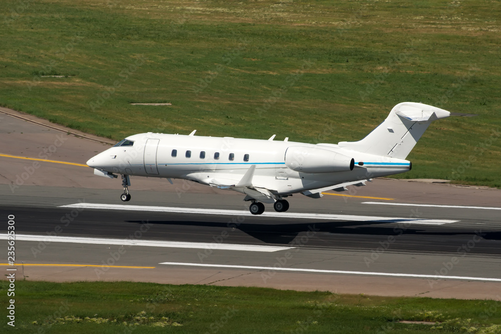 White modern private jet landing at airport White modern private jet landing at airport