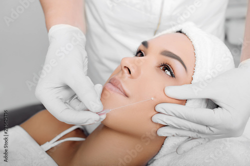 cropped woman face getting facelift , procedure mesothreads lifting skin photo