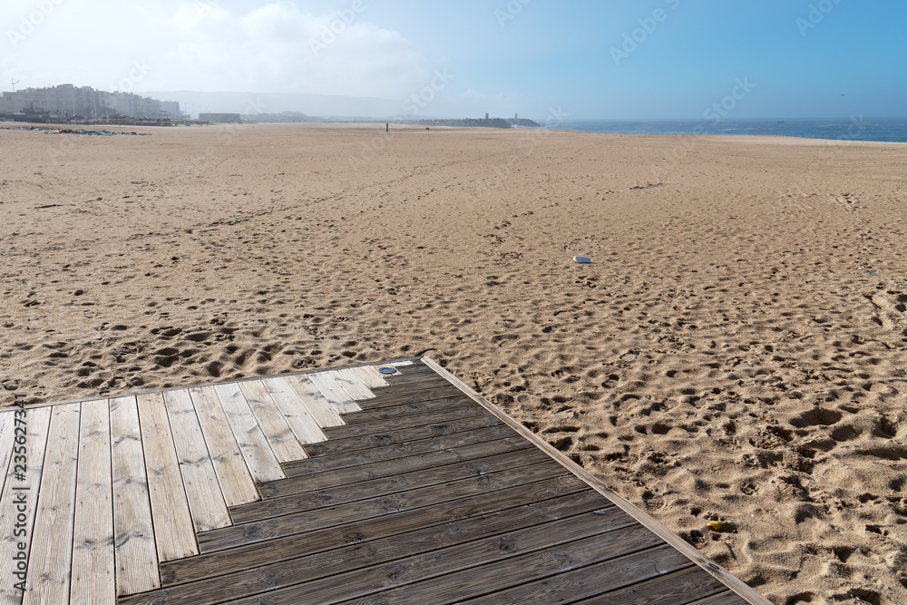 Wooden path by the ocean in Nazare, Portugal.
