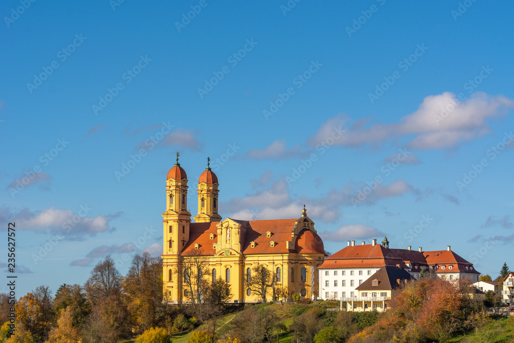 colors contrast with yellow church and blue sky in Ellwangen