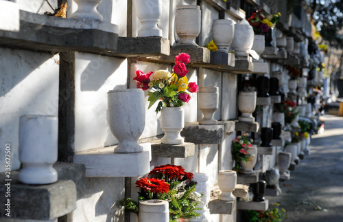 Urns with ashes in a columbarium wall of the cemetery photo