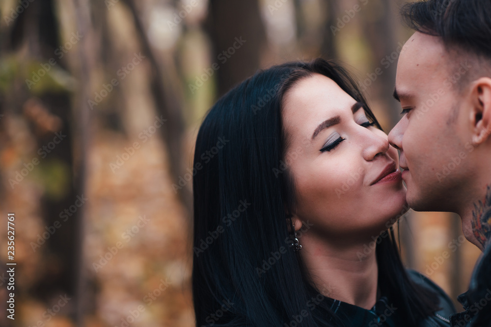 Fototapeta premium portrait of a young woman and a man walking in the autumn forest