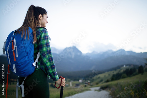Young woman hikes in the mountain with beautiful view