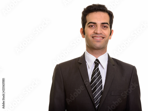 Portrait of young happy Persian businessman smiling