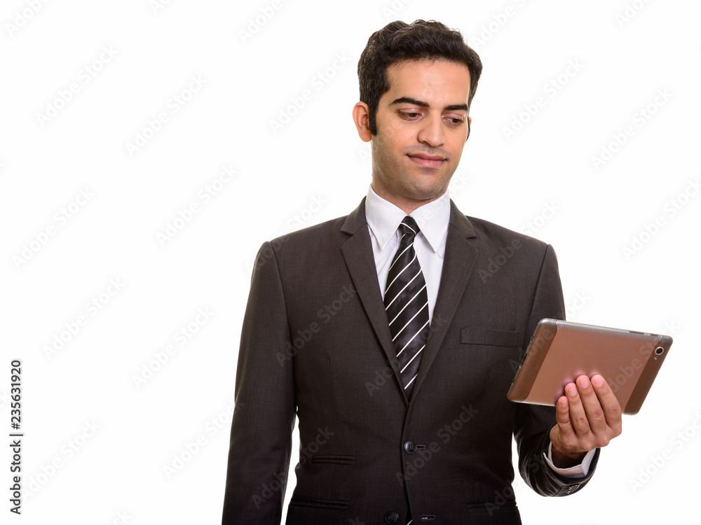 Portrait of young Persian businessman holding digital tablet Portrait of young Persian businessman holding digital tablet
