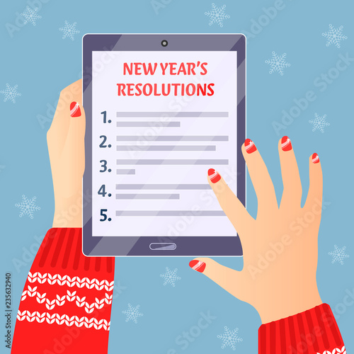 women'shands holding tablett with new years resolutions