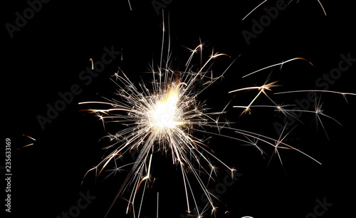 Ignited sparkler isolated on black background with clipping path