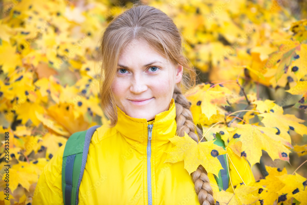 Pretty young woman with red hair in the autumn park with yellow fallen leaves Pretty young woman with red hair in the autumn park with yellow fallen leaves