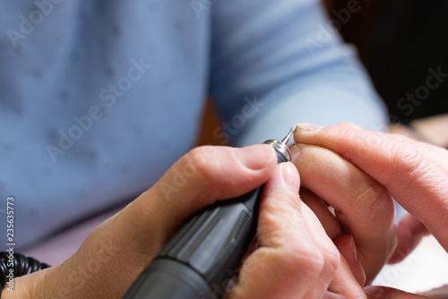 woman doing manicure. the process of creating a manicure hands close-up. nail care
