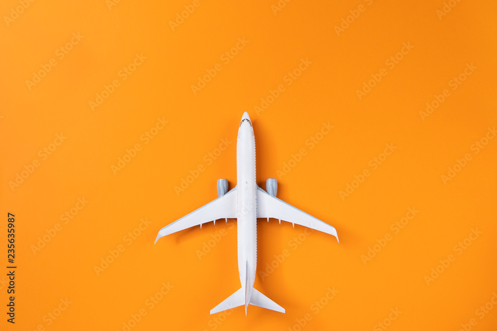Image of airplane isolated on empty orange background Image of airplane isolated on empty orange background
