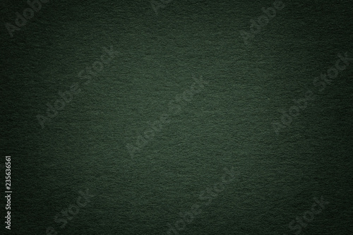 Texture of old dark green paper background, closeup. Structure of dense deep bluish cardboard.
