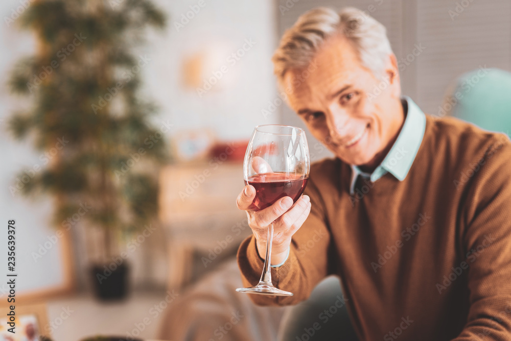 Man holding glass of French red wine in his hands Man holding glass of French red wine in his hands