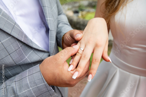 Bride and groom hands with wedding rings