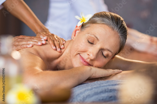 Woman receiving massage at spa photo
