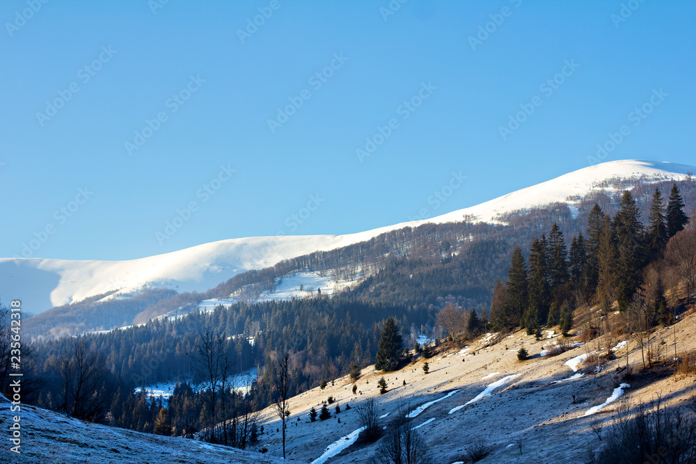 Winter mountain landscape. Mountains in the snow. The first snow in the mountains.