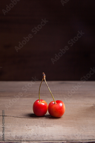 Yellow sweet cherry on wooden background.