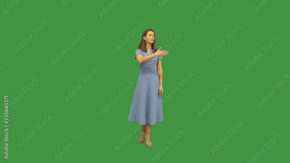 woman indicates the direction of the hand on a green screen woman indicates the direction of the hand on a green screen