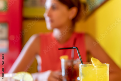 Young Woman Drinking Refreshments In Restaurant