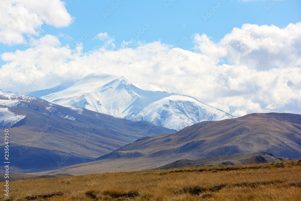 Natural landscape of the beautiful snow mountain with cloudy and large steppe at Western Mongolia