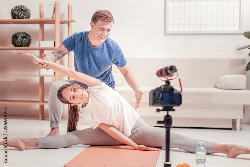 Tattoed man instructing a young woman Tattoed man instructing a young woman