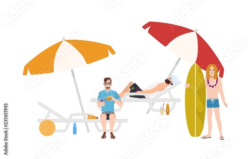 Group of guys in beachwear lying and sitting on sunloungers with umbrellas or...