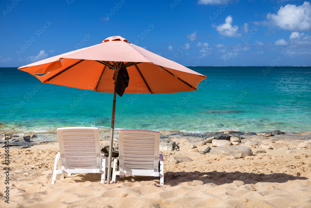 White chairs and, umbrella on a beach