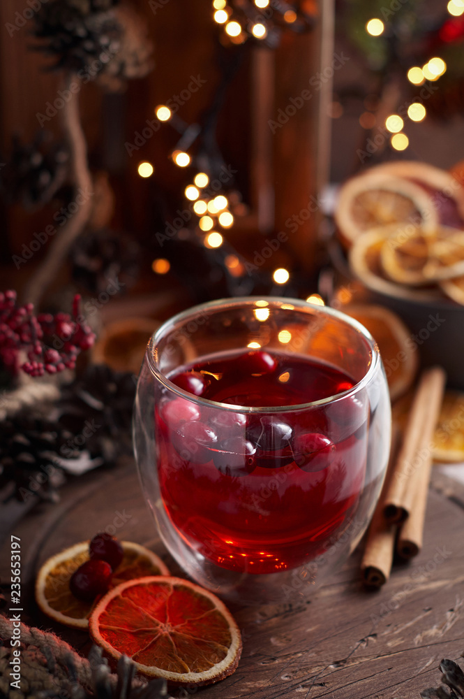 Fototapeta premium Glass of mulled wine with cranberry. Christmas or New Year drink