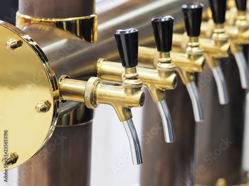 Row of polished beer taps