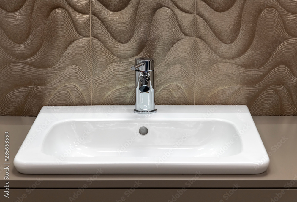 Fototapeta premium Fragment of bathroom with sink and faucet