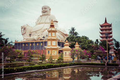 Massive statue of the Sitting Smiling Buddha at the Vinh Tranh Pagoda in My Tho, the Mekong Delta