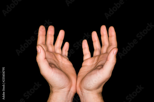 hands of a prayer on dark background. Croppped image
