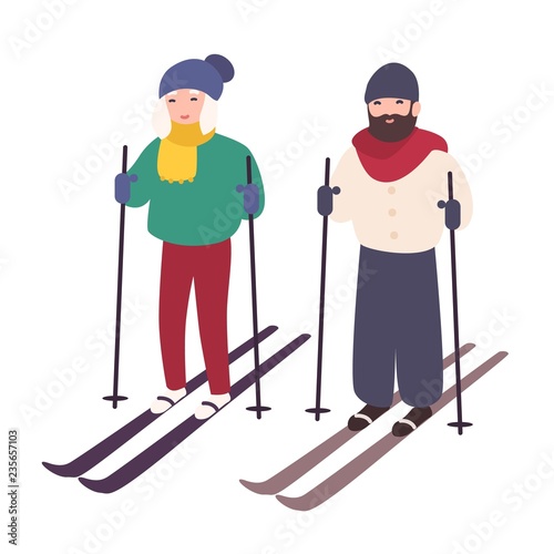Young couple skiing together. Happy smiling man and woman on skis. Winter spo...