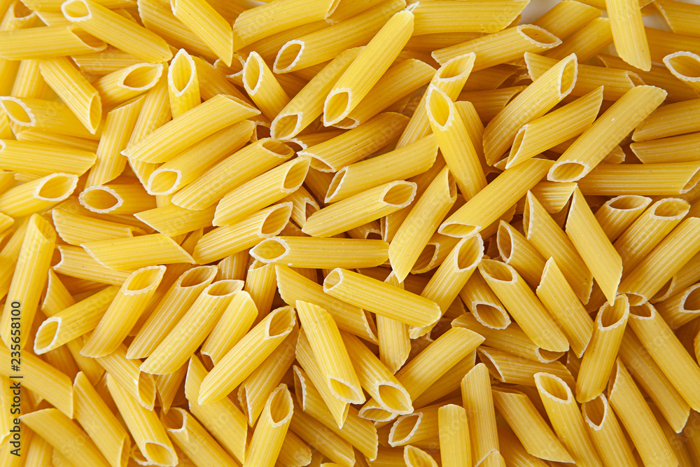 Nature agriculture penne. Concept of pasta packaging. Texture of penne for packing and 3D. Macro texture. Background image. Nature agriculture penne. Concept of pasta packaging. Texture of penne for packing and 3D. Macro texture. Background image.