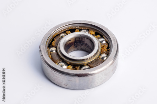 Used rusty metal ball bearing on white background.