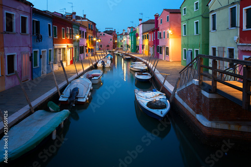 Old colorful houses and boats at night in Burano, Venice Italy © Shchipkova Elena