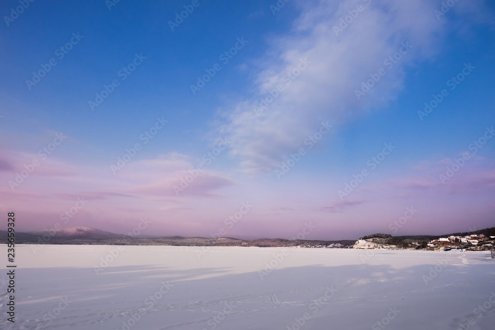 Beautiful landscape of frozen lake covered with snow and ice. Turgoyak Lake in Southern Urals, Russia. Beautiful landscape of frozen lake covered with snow and ice. Turgoyak Lake in Southern Urals, Russia.